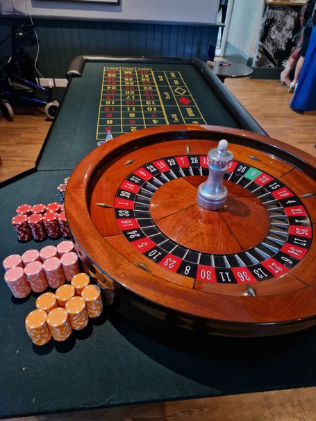 A roulette table with green cloth.