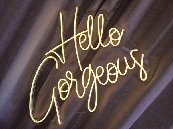 The neon lighting sign that says Hello Gorgeous.