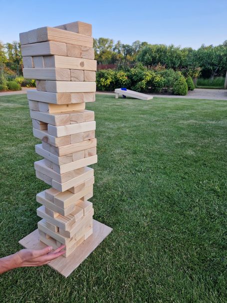 A stack of wooden bricks ready for a game of giant Jenga
